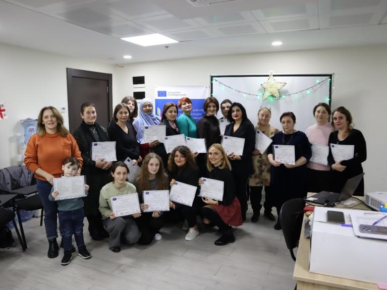 Batumi Shuttle participants holding their Shuttle participation certificates