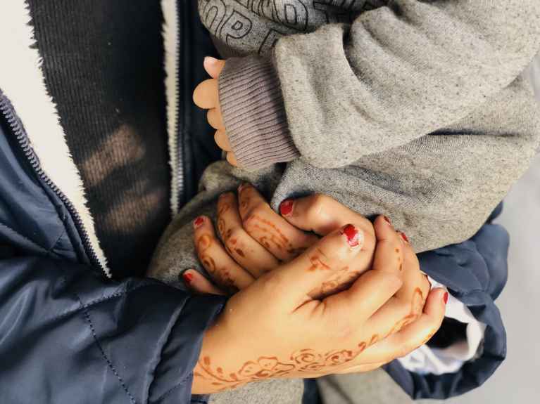 A mother holds her baby in one of Action Against Hunger’s Mother Baby Friendly Spaces in Gaza City. 1 December 2025. © Action Against Hunger