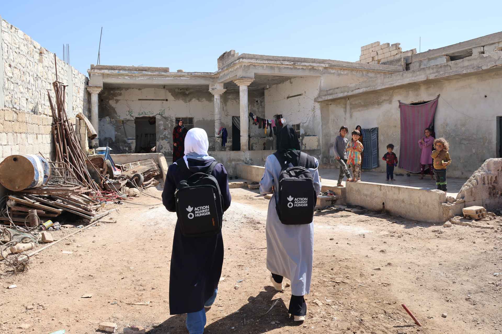 Community health workers conducting a follow-up visit at Huda's household.