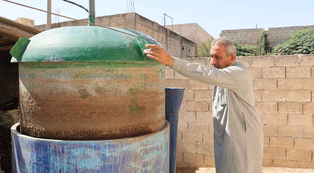 Hussein shows how the biogas unit works