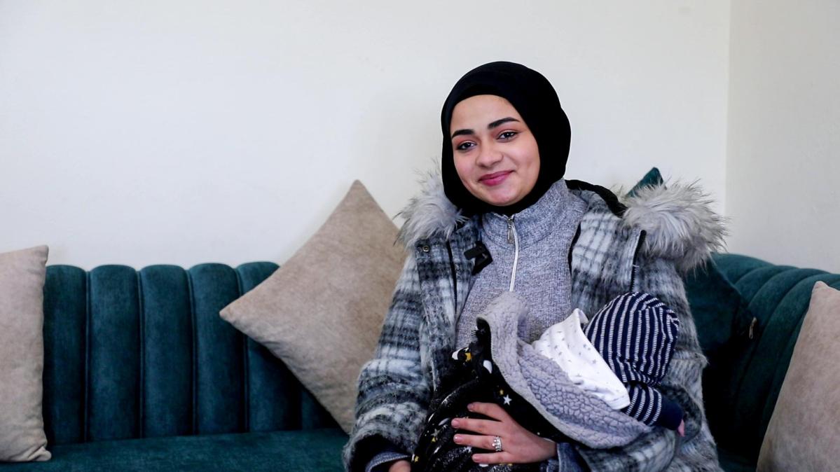 Noura holding her baby
