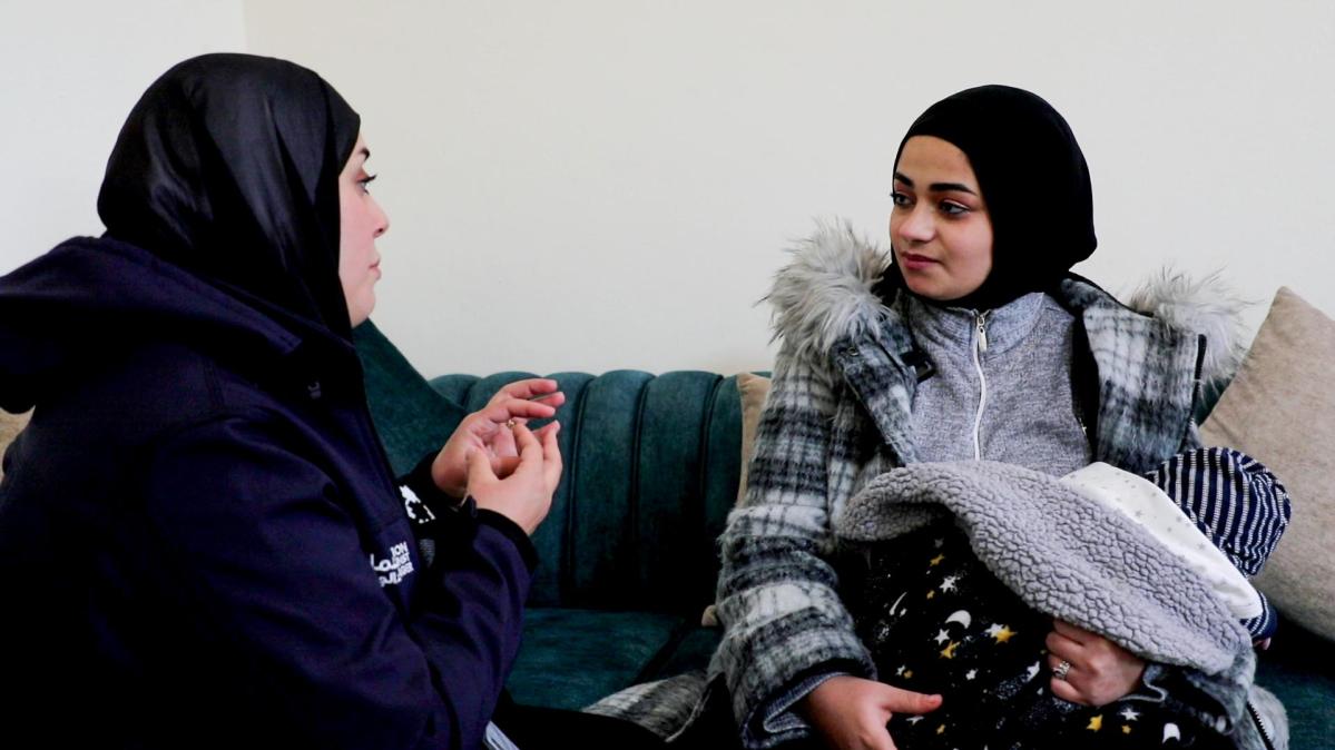 Noura receiving counselling from Action Against Hunger's midwife