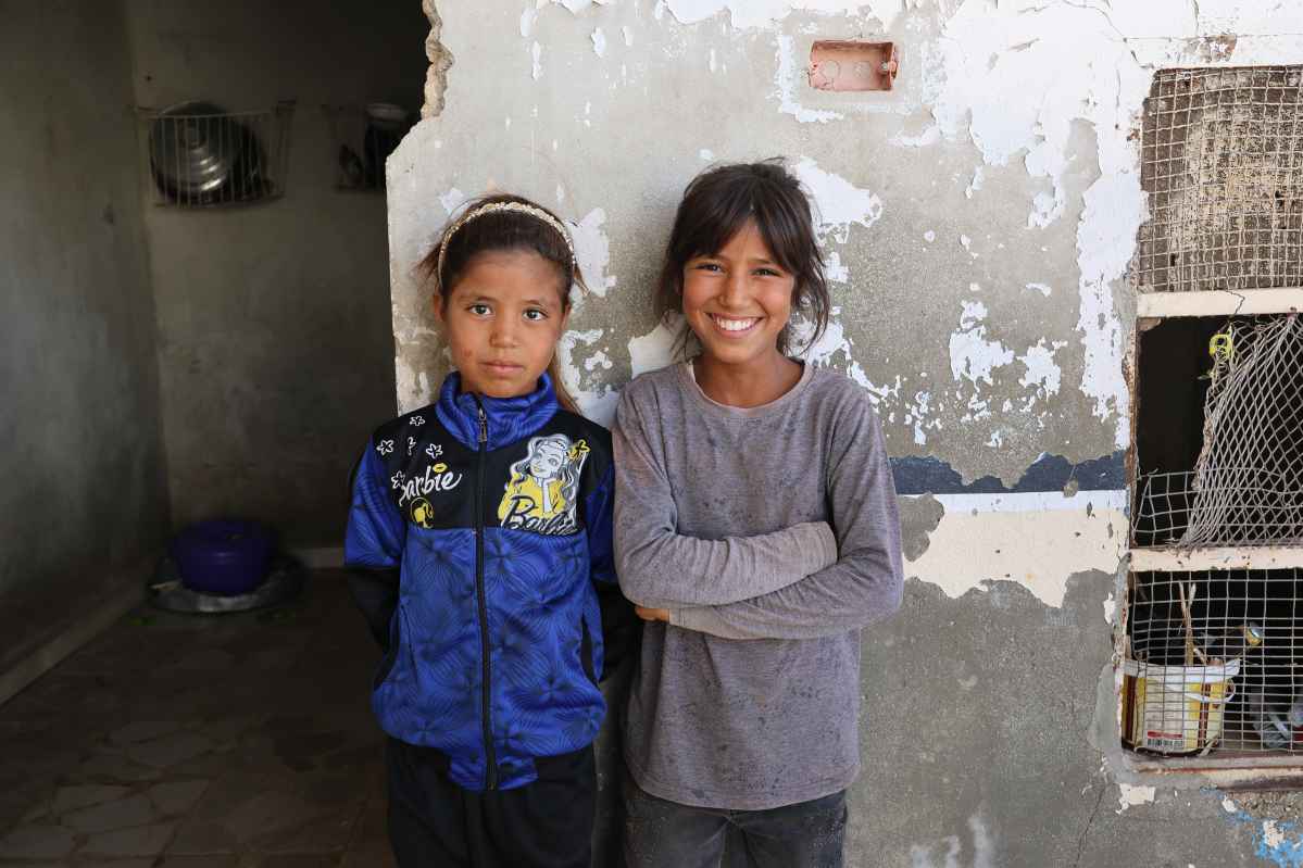 Rama (on the left) with her sister, after receiving treatment for her hand.